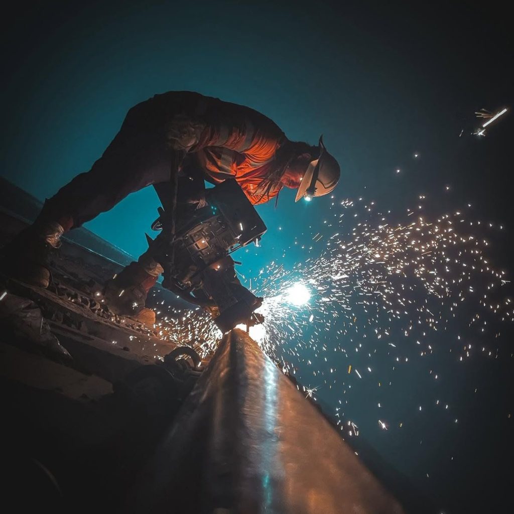 Matrix Unlimited rail worker using a rail cutting saw during track maintenance works