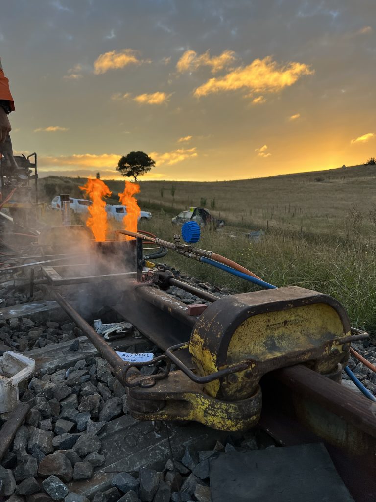 Specialist rail welding contractors carrying out flash butt welding during track renewal
