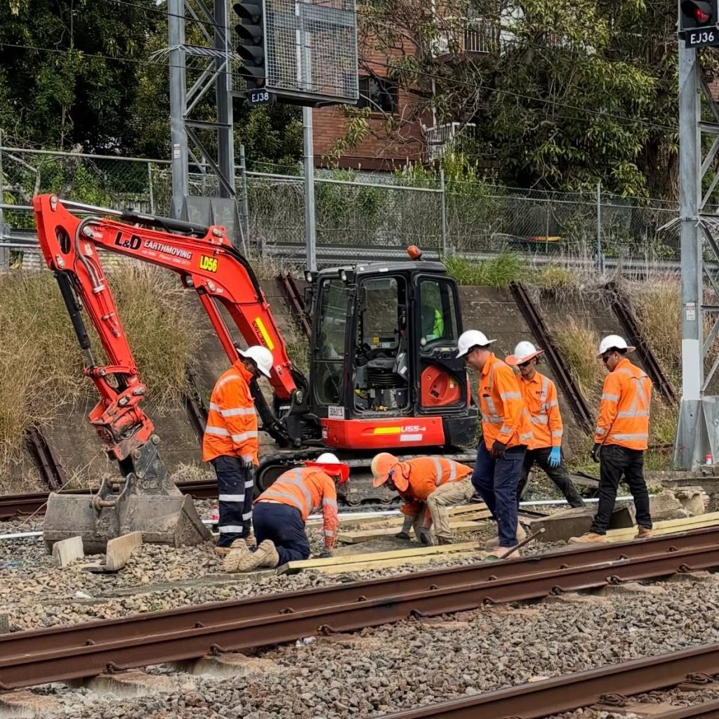 Wet hire excavator operating on a rail infrastructure project