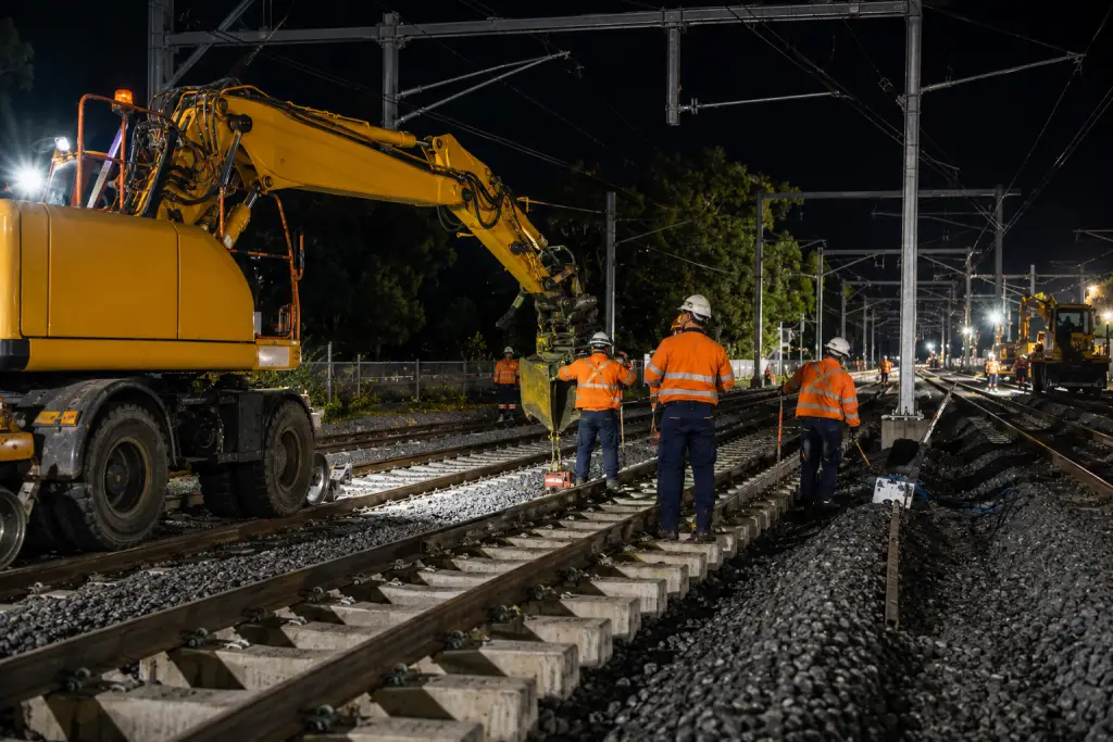 Rail crews and specialist plant completing coordinated track works during a rail possession