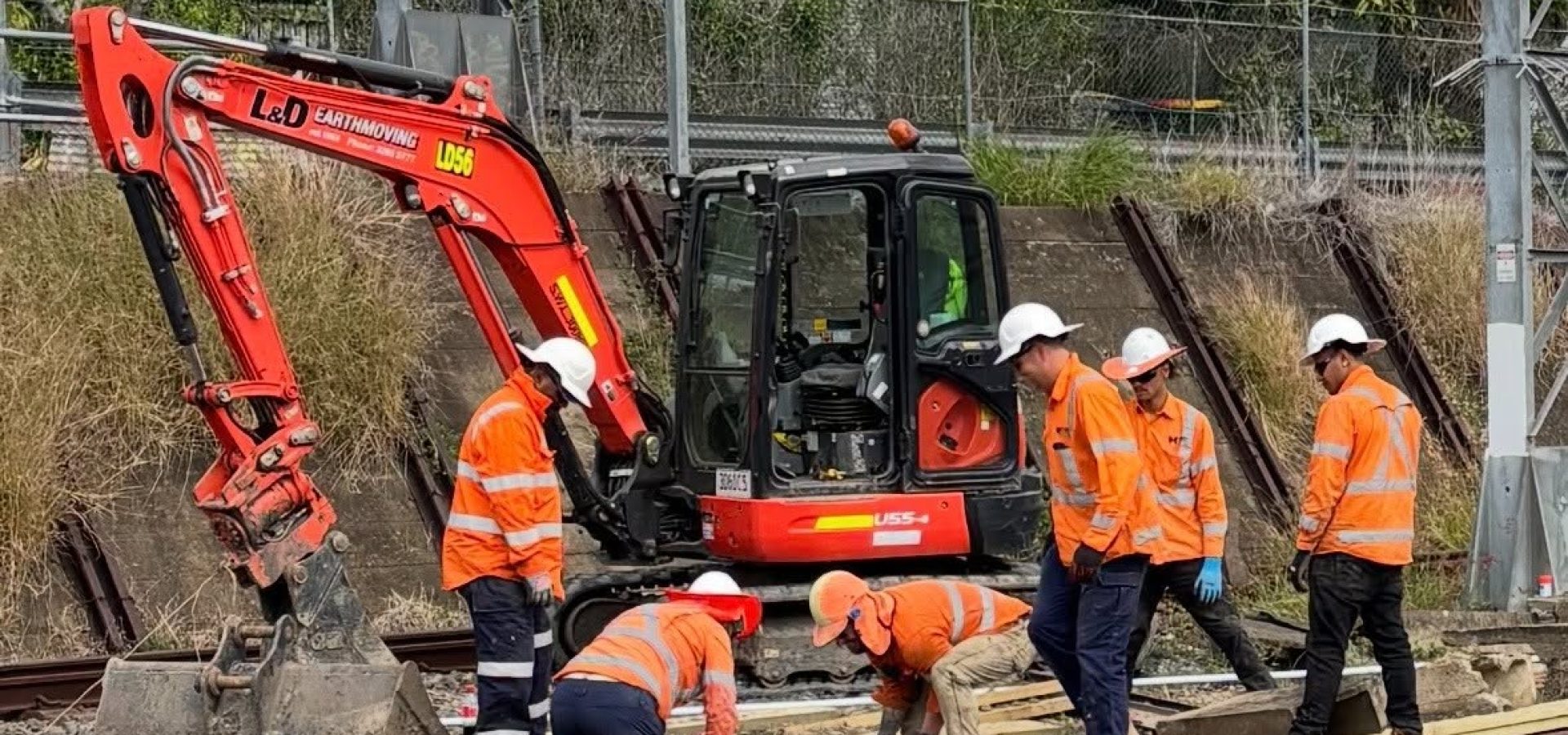 Wet hire excavator operating on a rail infrastructure project