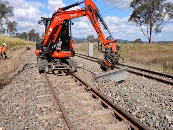 Hi-rail excavator supporting railway track works