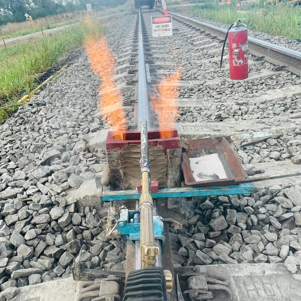 Rail welding contractors completing thermit welding on Australian railway infrastructure